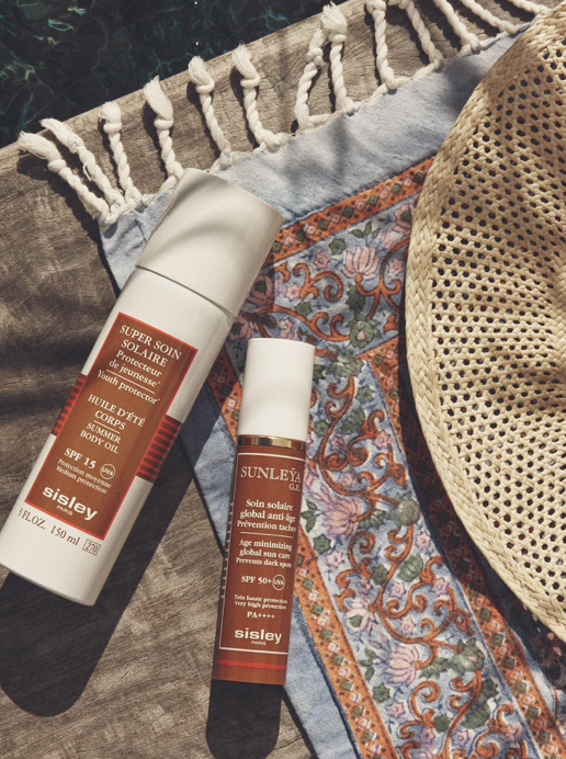 Sisley sun care travel flatlay